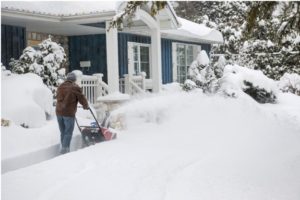 Man plowing chip seal driveway